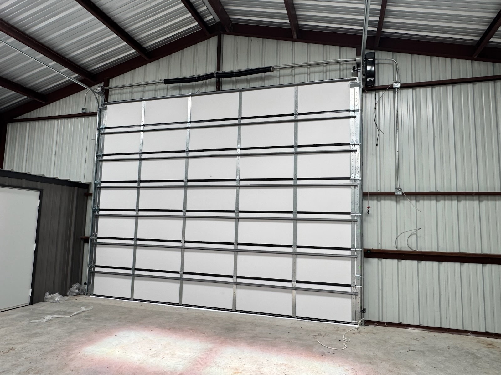 Interior of a commercial steel building with an insulated sectional door